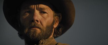 Movie still from “Jane Got a Gun” (2015), directed by Gavin O'Connor – A person wearing a cowboy hat; Close Up shot, Low angle