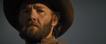 Movie still from “Jane Got a Gun” (2015), directed by Gavin O'Connor – A man with a cowboy hat on; Close Up shot, Low angle