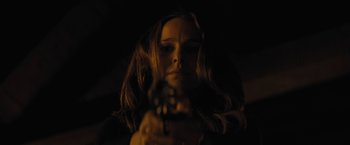 Movie still from “Jane Got a Gun” (2015), directed by Gavin O'Connor – A woman holding a gun in a dark room; Close Up shot, Low angle