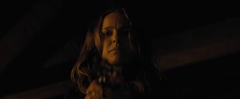 Movie still from “Jane Got a Gun” (2015), directed by Gavin O'Connor – A woman holding a guitar in a dimly - lit room; Close Up shot, Low angle