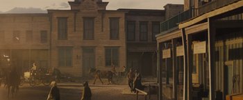 Movie still from “Jane Got a Gun” (2015), directed by Gavin O'Connor – An oil painting of an old western town with horses and carriages; Extreme Wide shot, Low angle
