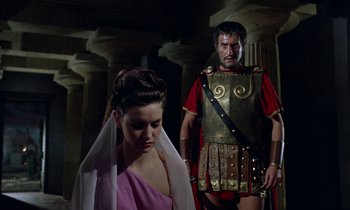 Movie still from “Jason and the Argonauts” (1963), directed by Don Chaffey – A man and a woman dressed in roman garb in front of columns; Medium shot, Low angle