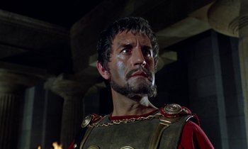 Movie still from “Jason and the Argonauts” (1963), directed by Don Chaffey – A man with a beard wearing a red and black uniform; Close Up shot, Low angle