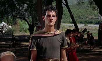 Movie still from “Jason and the Argonauts” (1963), directed by Don Chaffey – A man in a roman outfit standing in front of trees; Medium shot, Low angle
