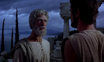 Movie still from “Jason and the Argonauts” (1963), directed by Don Chaffey – A man with a white beard is talking to another man; Medium shot, Over the shoulder angle
