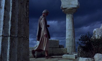 Movie still from “Jason and the Argonauts” (1963), directed by Don Chaffey – An old man walking in front of a pillar; Wide shot, Low angle