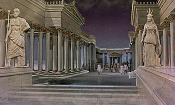 Movie still from “Jason and the Argonauts” (1963), directed by Don Chaffey – A group of people walking around a building with columns; Extreme Wide shot, High angle