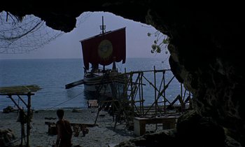 Movie still from “Jason and the Argonauts” (1963), directed by Don Chaffey – A boat is sitting in the water on the beach; Extreme Wide shot, High angle