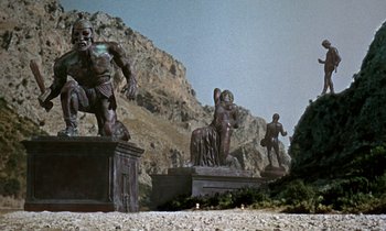 Movie still from “Jason and the Argonauts” (1963), directed by Don Chaffey – A group of bronze statues in front of a mountain; Extreme Wide shot, Low angle