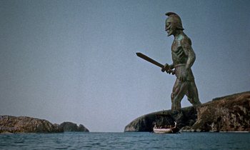 Movie still from “Jason and the Argonauts” (1963), directed by Don Chaffey – A statue of a man holding a sword in the water; Extreme Wide shot, Low angle