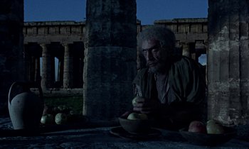Movie still from “Jason and the Argonauts” (1963), directed by Don Chaffey – An old man sitting at a table with a bowl of fruit; Medium shot, Low angle
