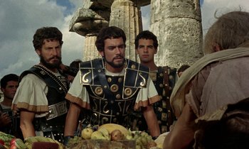 Movie still from “Jason and the Argonauts” (1963), directed by Don Chaffey – A group of men standing next to each other in roman garb; Medium shot, Over the shoulder angle