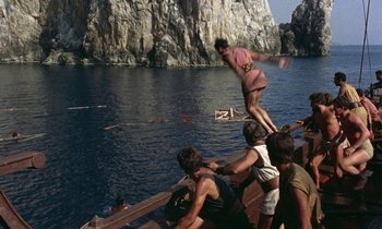 Movie still from “Jason and the Argonauts” (1963), directed by Don Chaffey – A group of young people on a boat in the water; Extreme Wide shot, High angle
