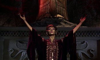 Movie still from “Jason and the Argonauts” (1963), directed by Don Chaffey – A man in a purple robe is holding his hands up; Medium shot, Low angle