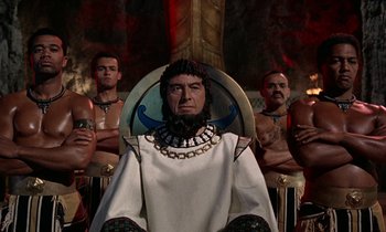 Movie still from “Jason and the Argonauts” (1963), directed by Don Chaffey – An image of a man sitting on a throne in front of a group of men; Medium shot, Low angle
