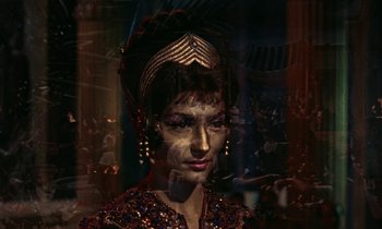 Movie still from “Jason and the Argonauts” (1963), directed by Don Chaffey – A woman in a fancy costume is reflected in a mirror; Close Up shot, High angle