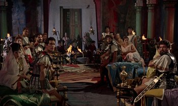 Movie still from “Jason and the Argonauts” (1963), directed by Don Chaffey – A group of people sitting around a room; Wide shot, High angle