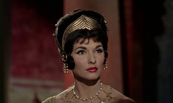 Movie still from “Jason and the Argonauts” (1963), directed by Don Chaffey – A woman in a gold headpiece and a necklace; Close Up shot, Low angle