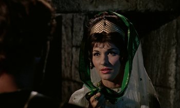 Movie still from “Jason and the Argonauts” (1963), directed by Don Chaffey – A woman wearing a green and gold headpiece; Close Up shot, Over the shoulder angle