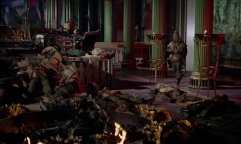 Movie still from “Jason and the Argonauts” (1963), directed by Don Chaffey – A living room filled with furniture and a fire pit; Wide shot, High angle