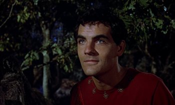 Movie still from “Jason and the Argonauts” (1963), directed by Don Chaffey – A man wearing a red shirt in the woods; Close Up shot, Low angle