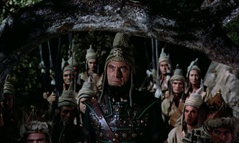 Movie still from “Jason and the Argonauts” (1963), directed by Don Chaffey – A group of men in costume standing next to each other in a forest; Medium shot, High angle