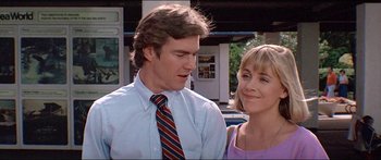 Movie still from “Jaws 3-D” (1983), directed by Joe Alves – A man and a woman standing next to each other; Close Up shot, Low angle