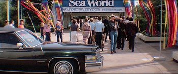 Movie still from “Jaws 3-D” (1983), directed by Joe Alves – A crowd of people walking down a street; Wide shot, High angle