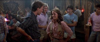 Movie still from “Jaws 3-D” (1983), directed by Joe Alves – A group of people standing around talking to each other; Medium shot, Over the shoulder angle