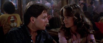 Movie still from “Jaws 3-D” (1983), directed by Joe Alves – A man and a woman sitting next to each other; Close Up shot, Over the shoulder angle