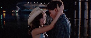 Movie still from “Jaws 3-D” (1983), directed by Joe Alves – A man and a woman dancing in front of a building at night; Medium shot, Over the shoulder angle