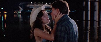 Movie still from “Jaws 3-D” (1983), directed by Joe Alves – A man and a woman in cowboy hats kissing each other; Close Up shot, Low angle