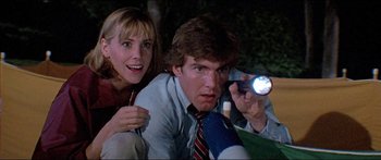 Movie still from “Jaws 3-D” (1983), directed by Joe Alves – A man and a woman are holding a flashlight; Close Up shot, Low angle