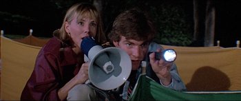 Movie still from “Jaws 3-D” (1983), directed by Joe Alves – A man and a woman holding a megaphone; Medium shot, Low angle