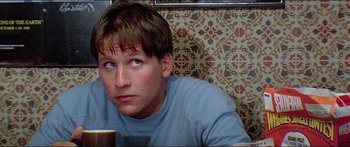 Movie still from “Jaws 3-D” (1983), directed by Joe Alves – A person sitting at a table; Close Up shot, Low angle