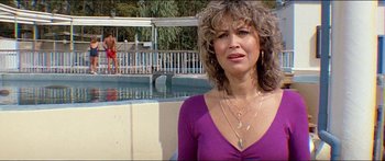 Movie still from “Jaws 3-D” (1983), directed by Joe Alves – A person near a swimming pool; Medium shot, Low angle