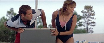 Movie still from “Jaws 3-D” (1983), directed by Joe Alves – A woman in a black and pink bathing suit and a man; Medium shot, Low angle