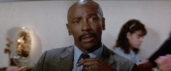 Movie still from “Jaws 3-D” (1983), directed by Joe Alves – A man in a suit and tie with a ring; Close Up shot, Low angle