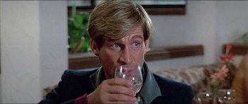 Movie still from “Jaws 3-D” (1983), directed by Joe Alves – A person holding a glass of wine; Close Up shot, Low angle