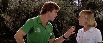 Movie still from “Jaws 3-D” (1983), directed by Joe Alves – A man in a green shirt is talking to someone; Close Up shot, Over the shoulder angle