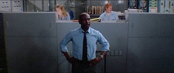 Movie still from “Jaws 3-D” (1983), directed by Joe Alves – A man standing in front of a cubicle with two cubicles in the background; Medium shot, Low angle