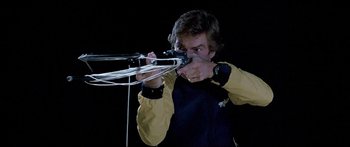 Movie still from “Jaws 3-D” (1983), directed by Joe Alves – A man in a yellow and black jacket holding a camera; Close Up shot, Low angle