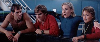 Movie still from “Jaws 3-D” (1983), directed by Joe Alves – A man and a woman sitting next to each other; Medium shot, Low angle