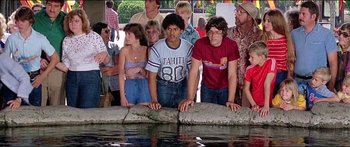 Movie still from “Jaws 3-D” (1983), directed by Joe Alves – A group of people standing next to a body of water; Medium shot, Low angle