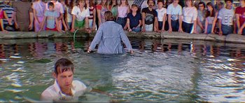 Movie still from “Jaws 3-D” (1983), directed by Joe Alves – A group of people standing in a body of water; Wide shot, High angle