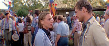 Movie still from “Jaws 3-D” (1983), directed by Joe Alves – A woman standing in a crowd of people outside; Close Up shot, Over the shoulder angle