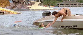 Movie still from “Jaws 3-D” (1983), directed by Joe Alves – A man helping a woman out of the water in a boat; Wide shot, High angle