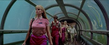 Movie still from “Jaws 3-D” (1983), directed by Joe Alves – A group of people walking down a train track; Medium shot, Low angle