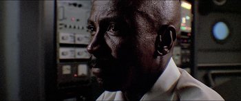 Movie still from “Jaws 3-D” (1983), directed by Joe Alves – A man's face in front of an electronic device; Close Up shot, Low angle