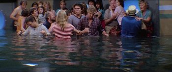 Movie still from “Jaws 3-D” (1983), directed by Joe Alves – A group of people standing in a body of water; Medium shot, High angle
